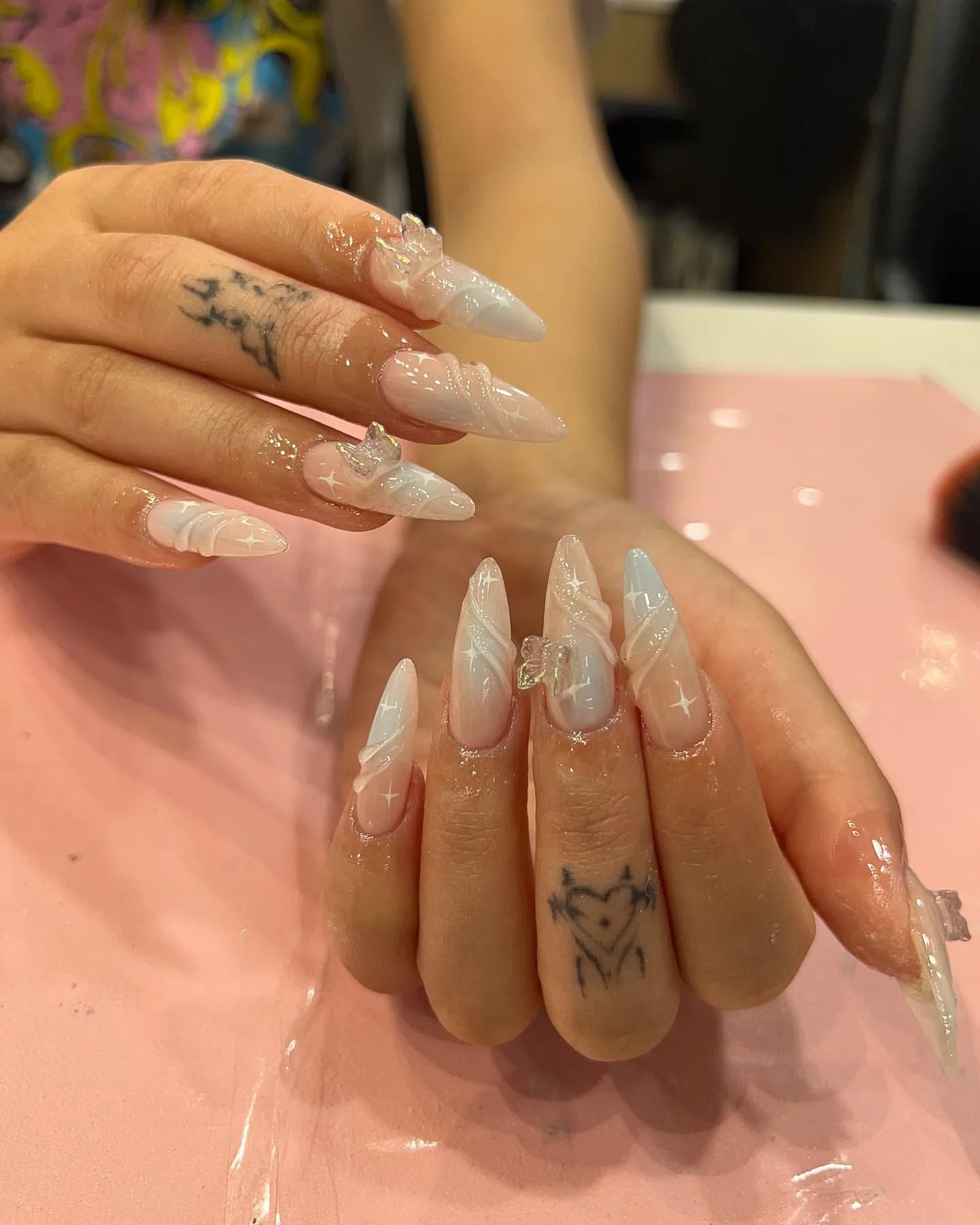 Milky-nude almond nails with molten liquid-silver 3D metallic frames