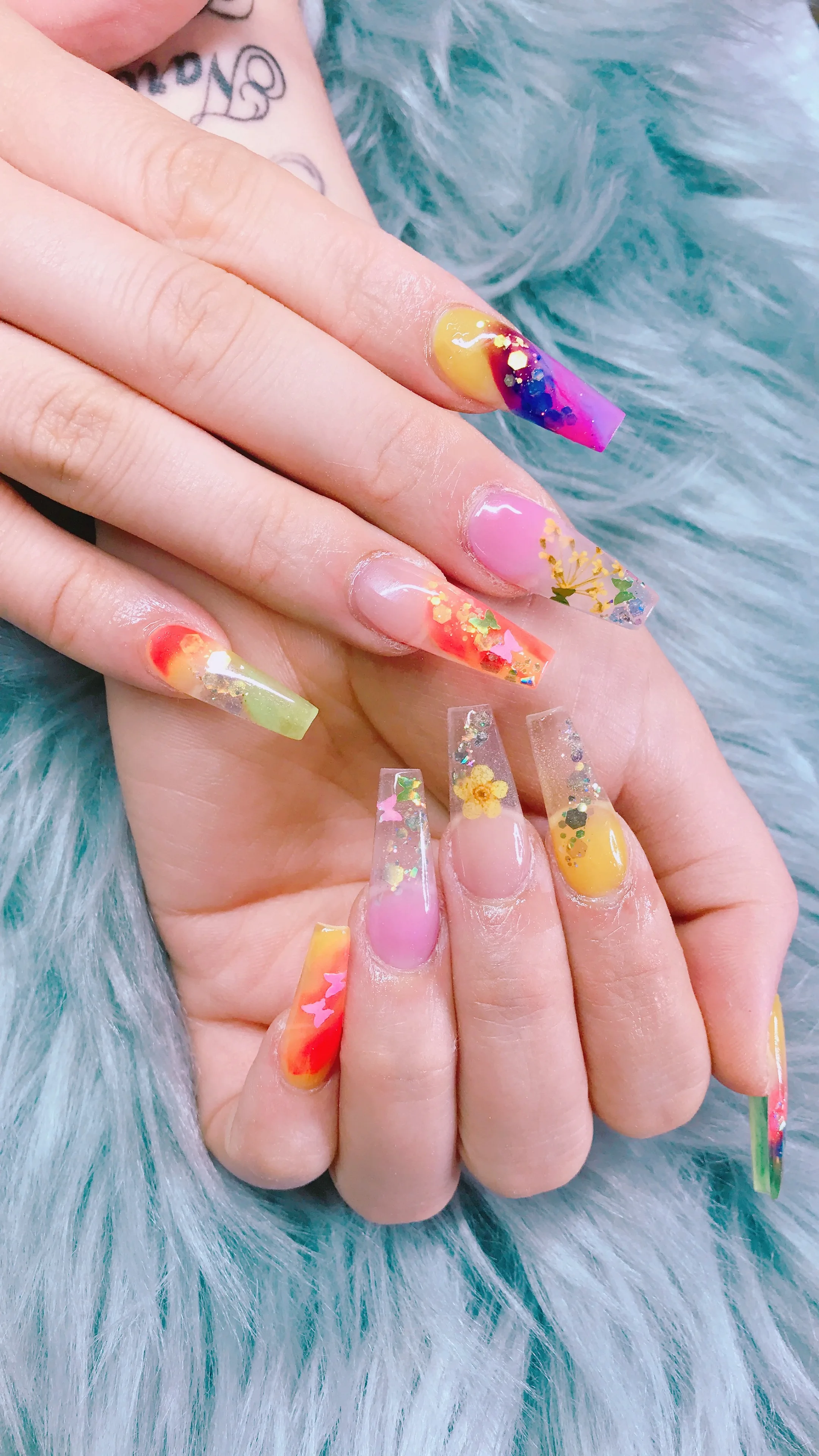 Colourful jelly encapsulated coffin nails with dried flowers and butterflies