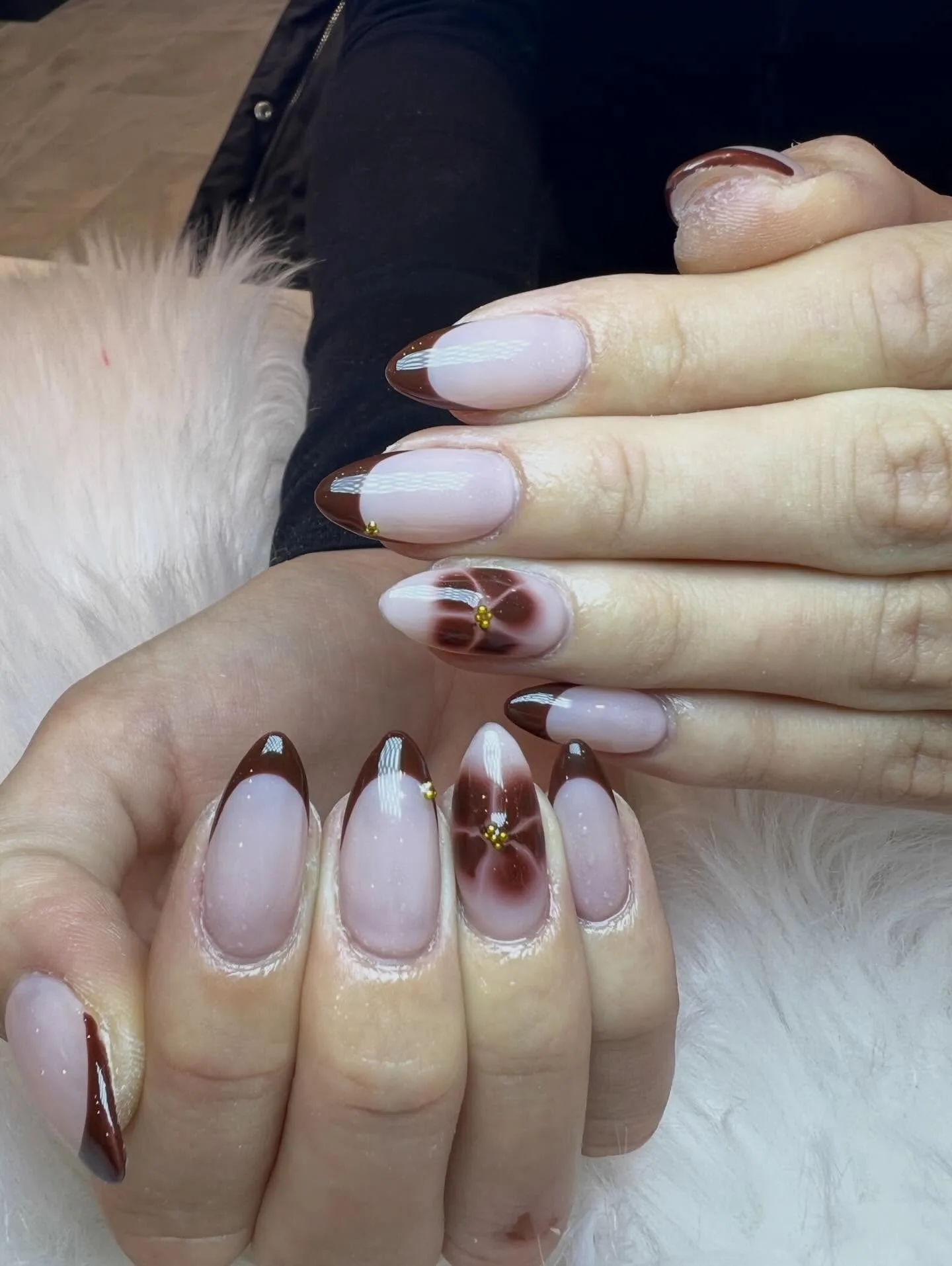 Soft brown French almond nails with flower art and gold beads