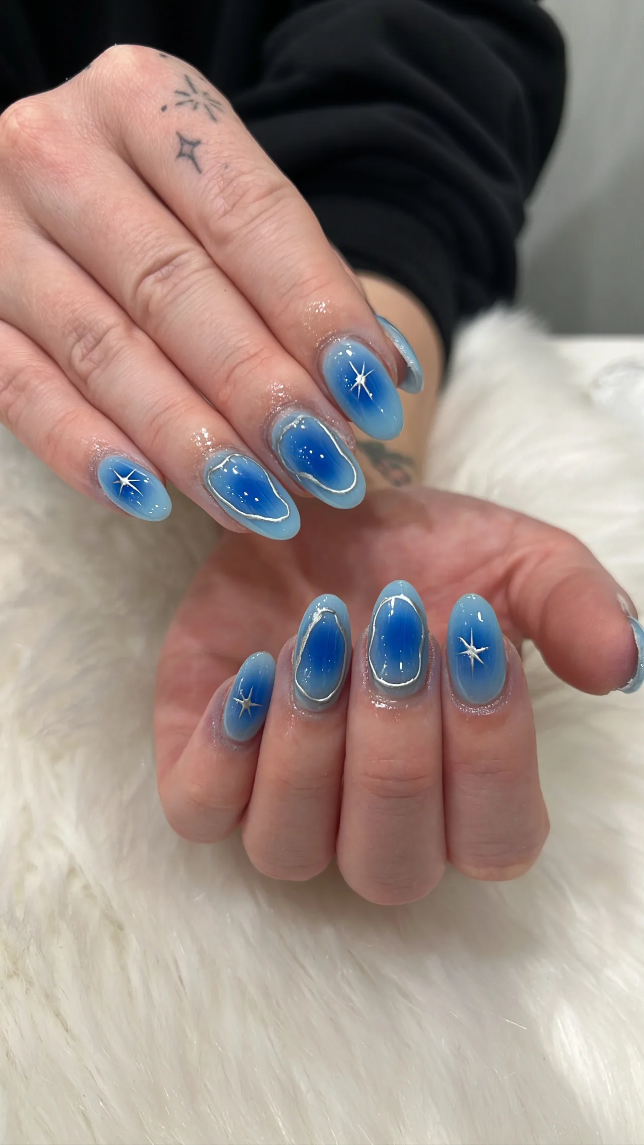 Blue aura nails with silver outlines, star art and white fur
