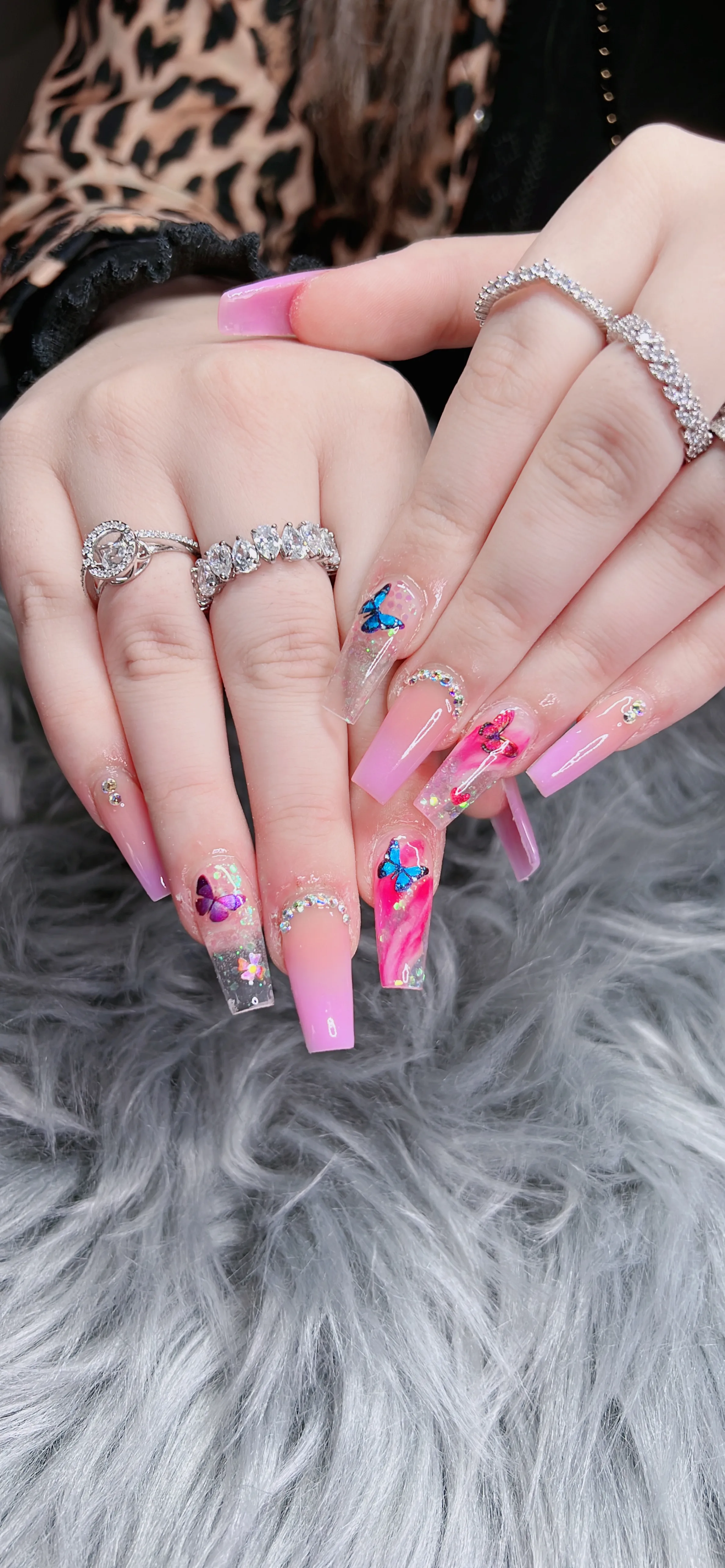 Pink ombre coffin nails with butterflies and gems