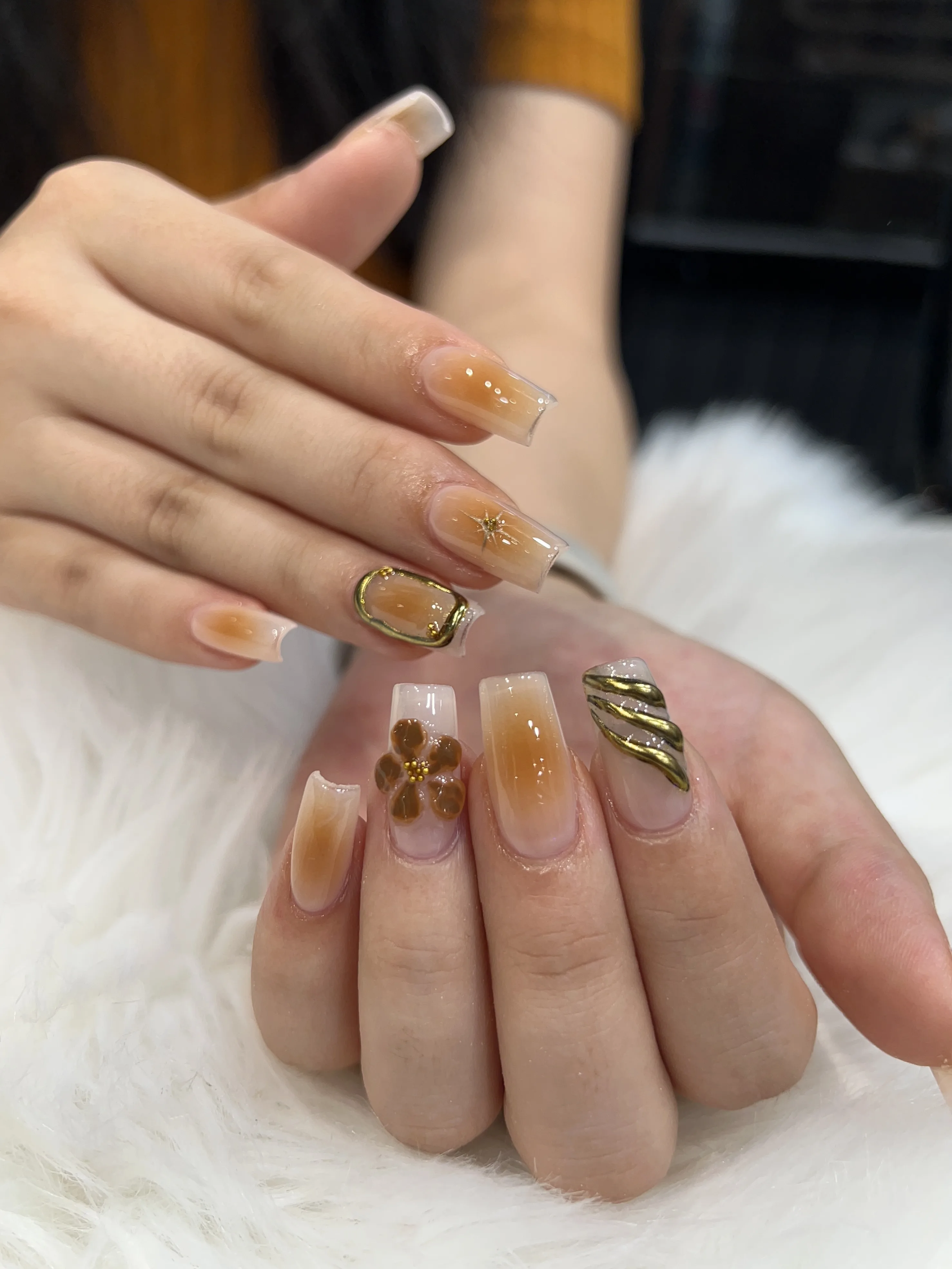 Nude caramel ombre coffin nails with gold 3D flower and swirl art