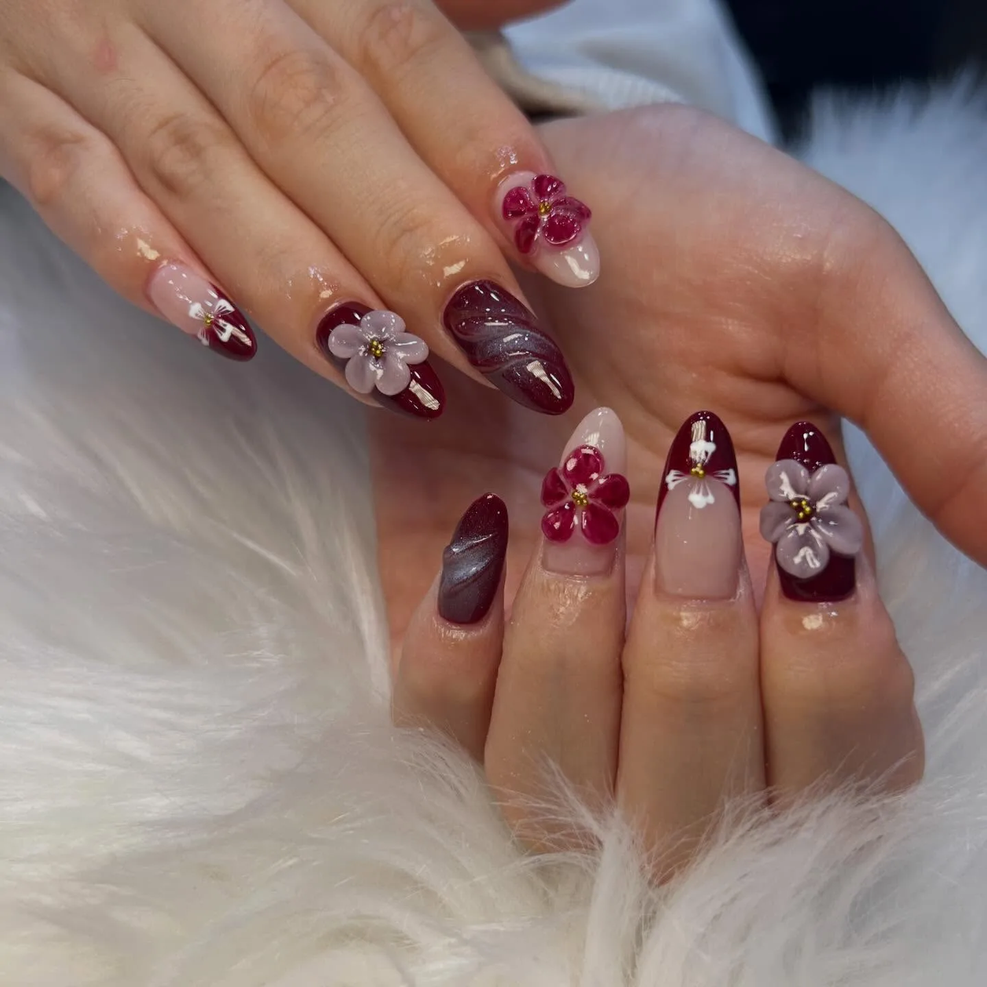 Burgundy 3D floral almond nails on white fur
